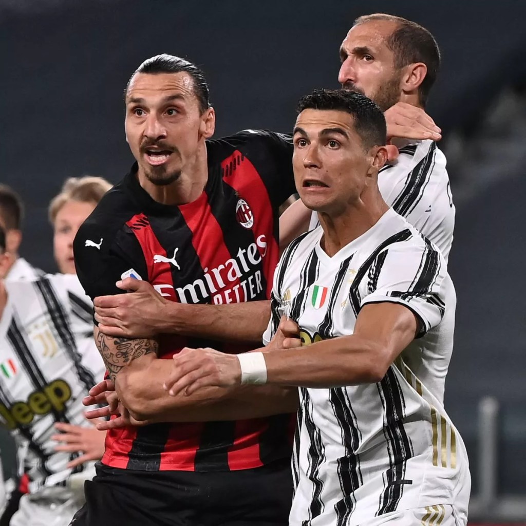 Football players wrestling for the ball on the pitch